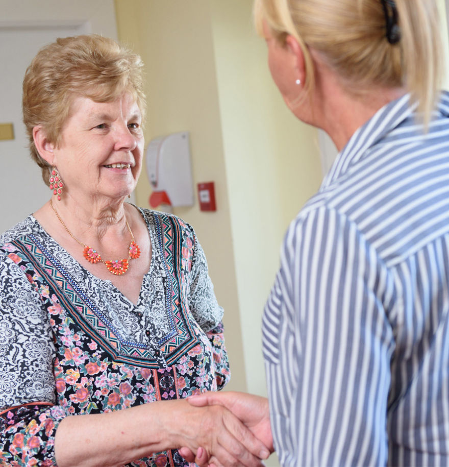 team member and family member shaking hands